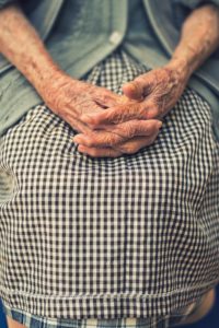Elderly lady holding her hands.
